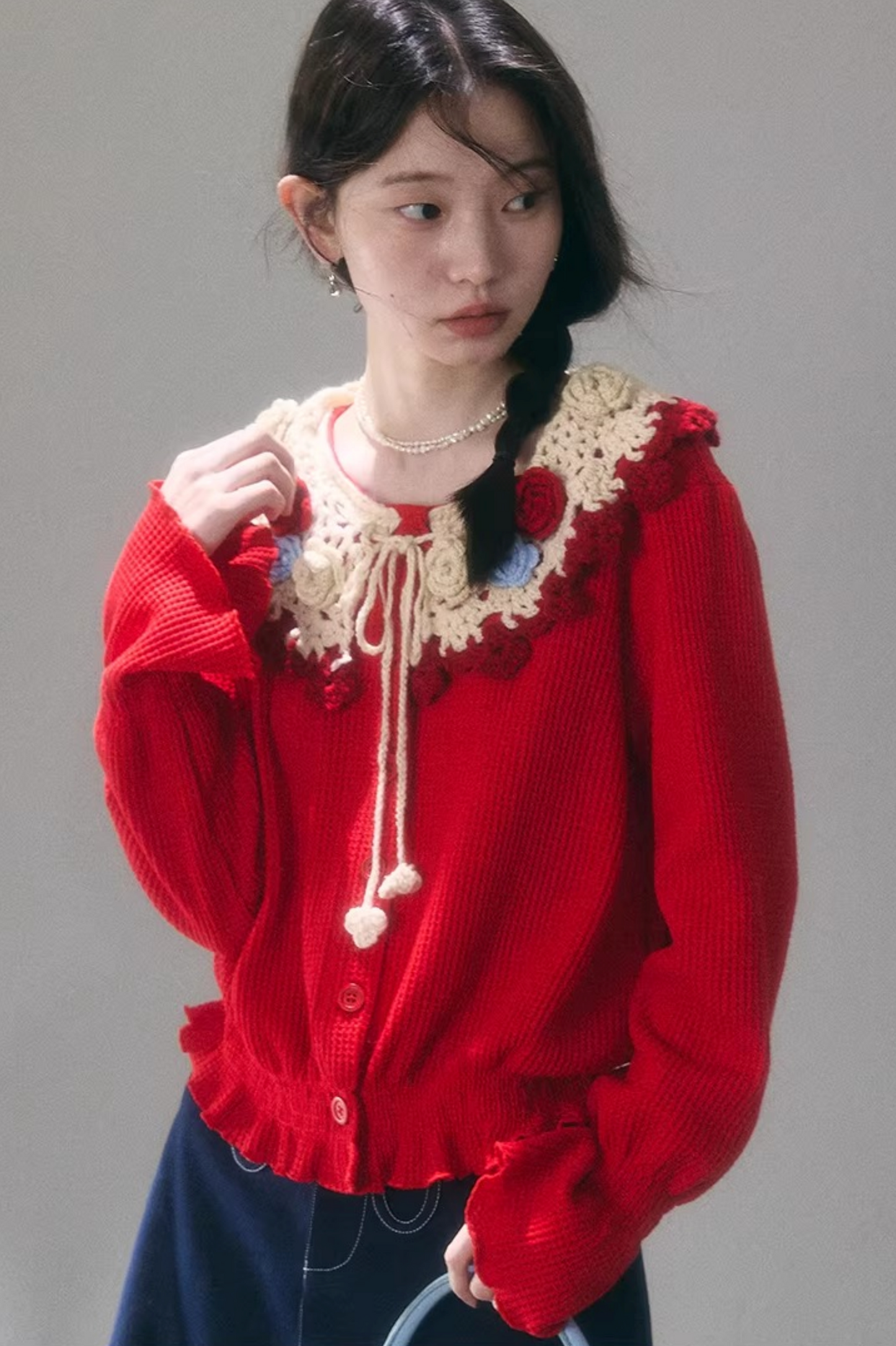 Gehäkelte Strickjacke mit floraler Kamelie