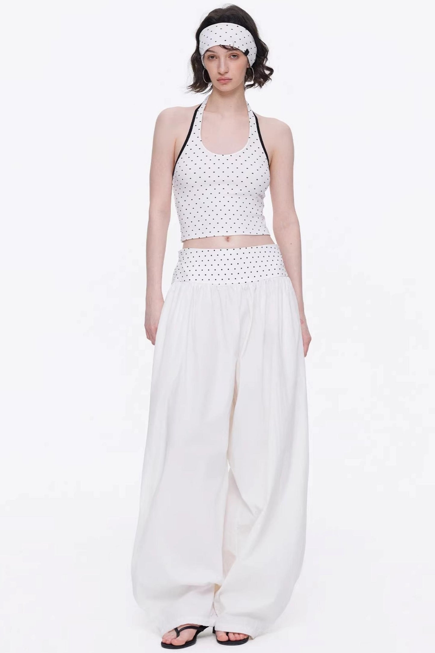 Elegant off-white minimalist knitted set featuring a tube top and wide-leg pants