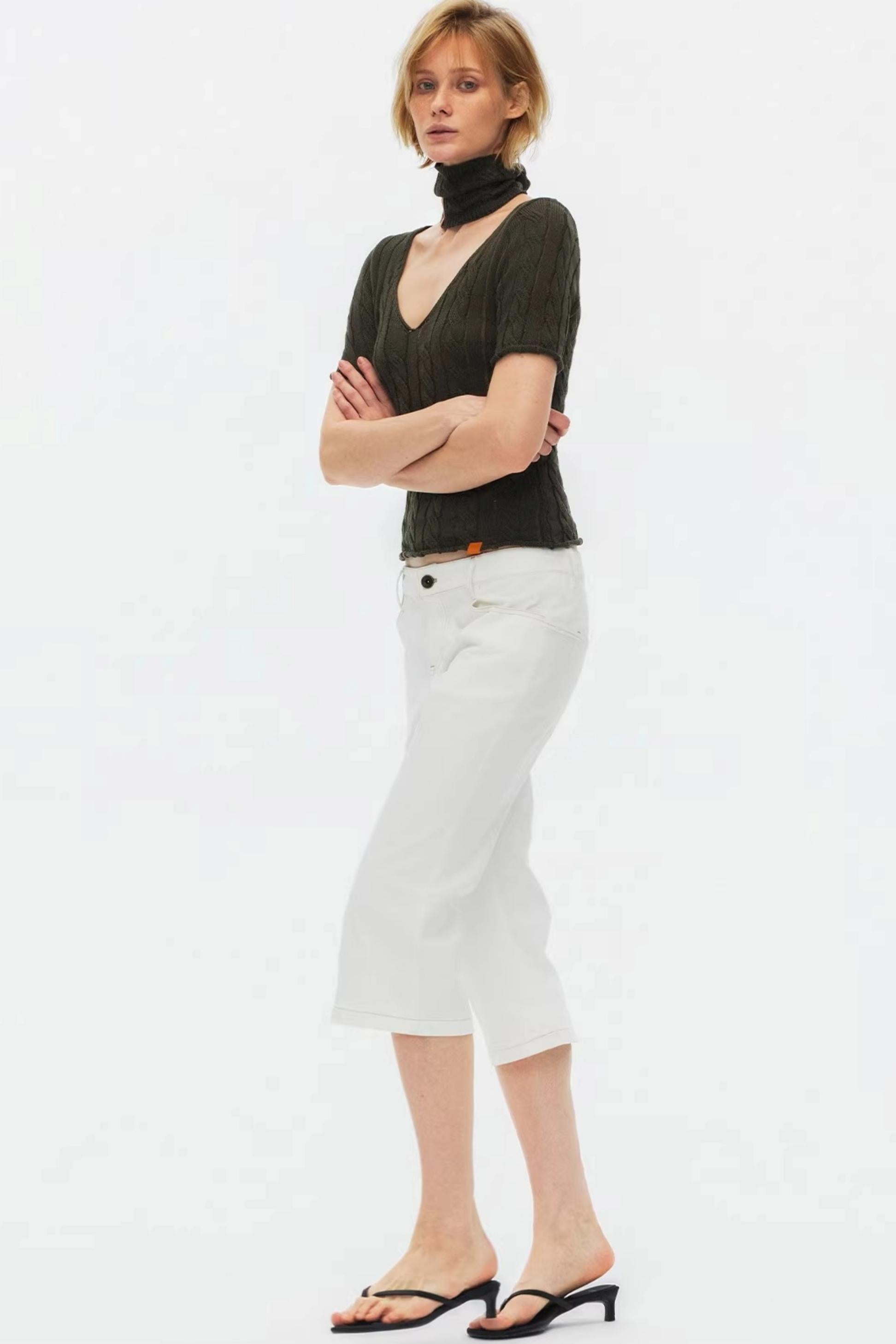 Classic white high-waisted flared jeans with unique stitching detail