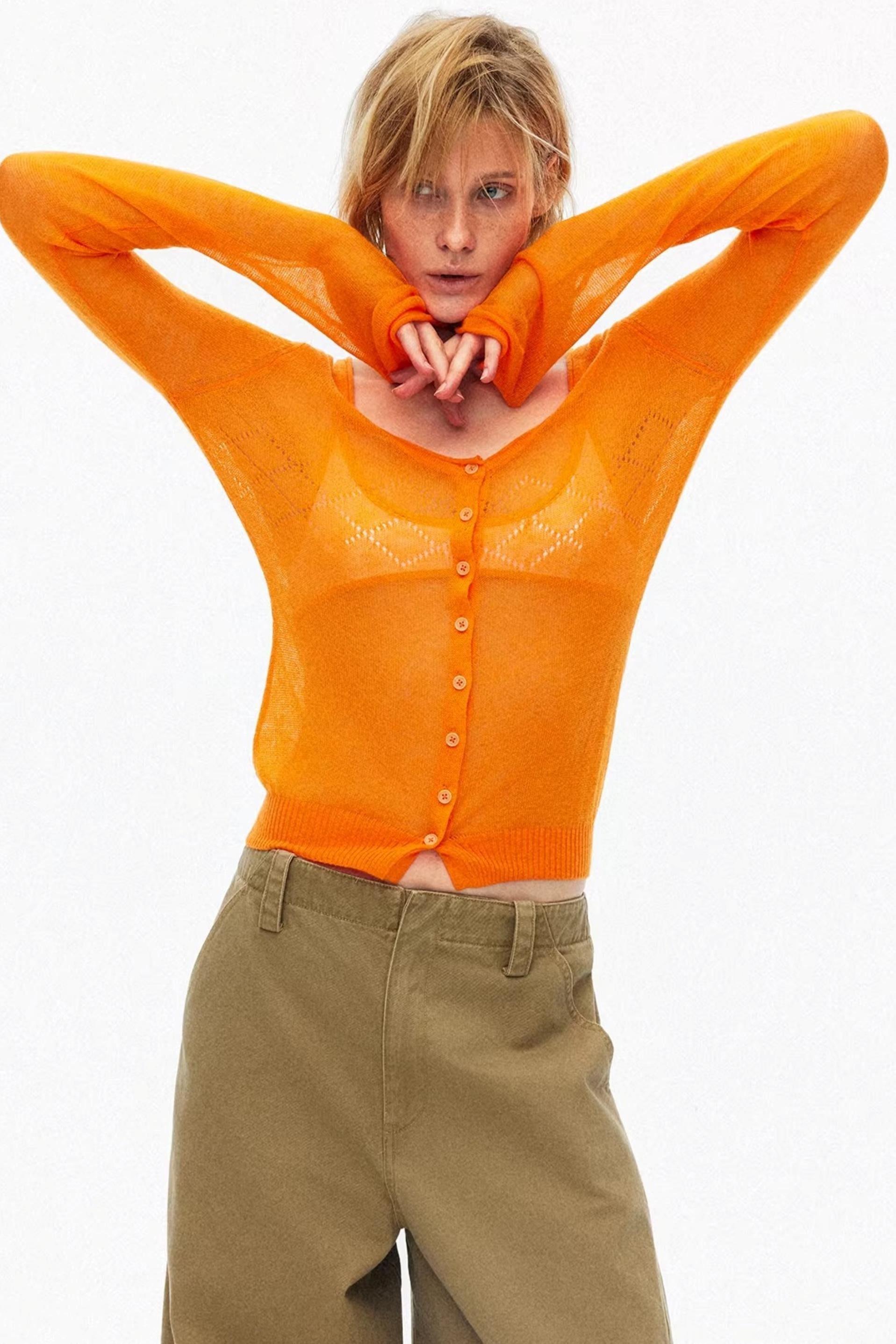 Vibrant orange lightweight hollow-out knit cardigan for stylish layering