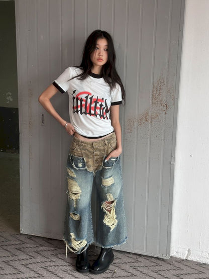 Low-rise ripped camouflage patchwork denim