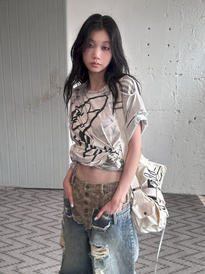 Low-rise ripped camouflage patchwork denim