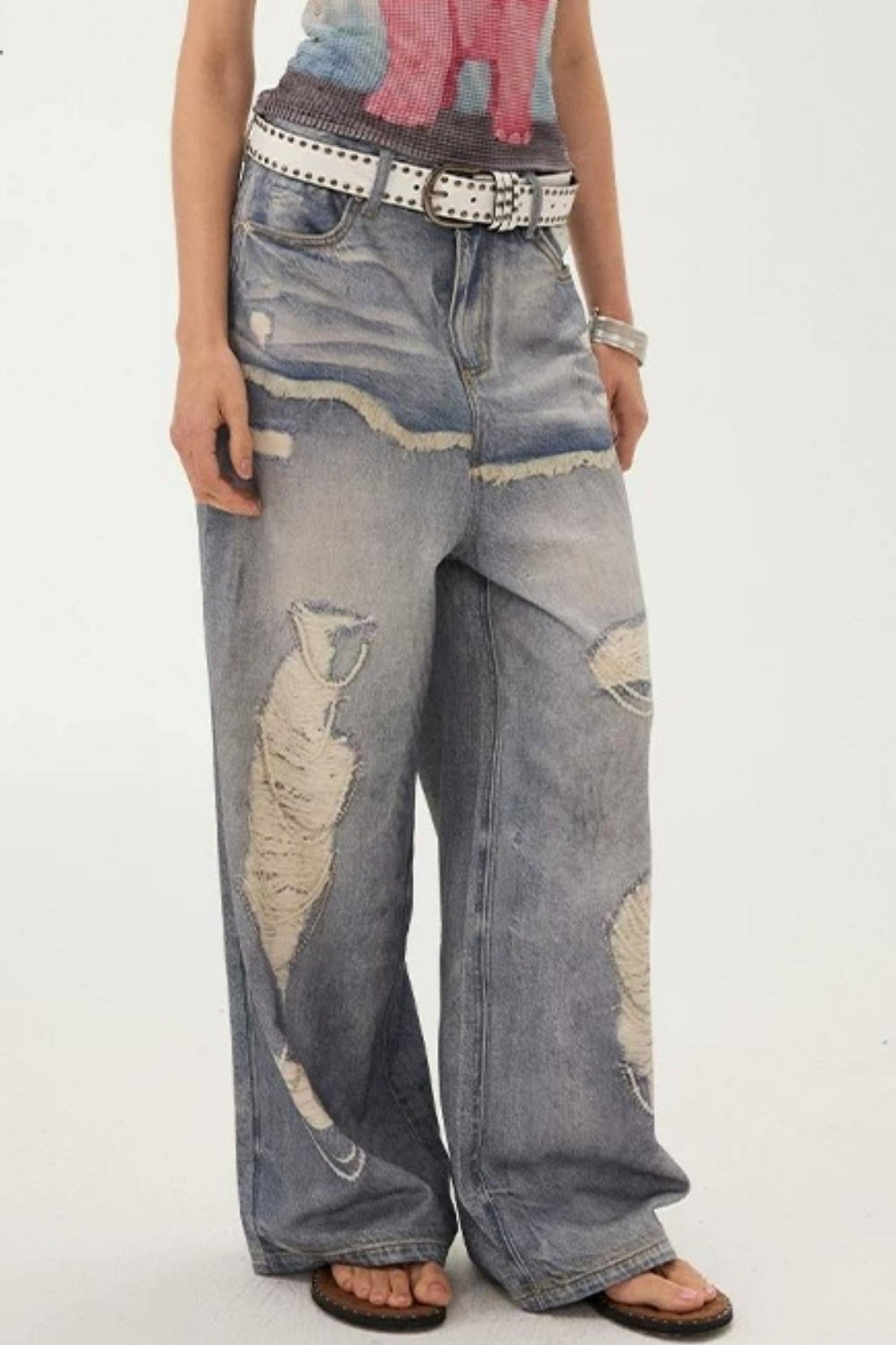 Jeans a gamba larga con stampa effetto strappato e look a strati