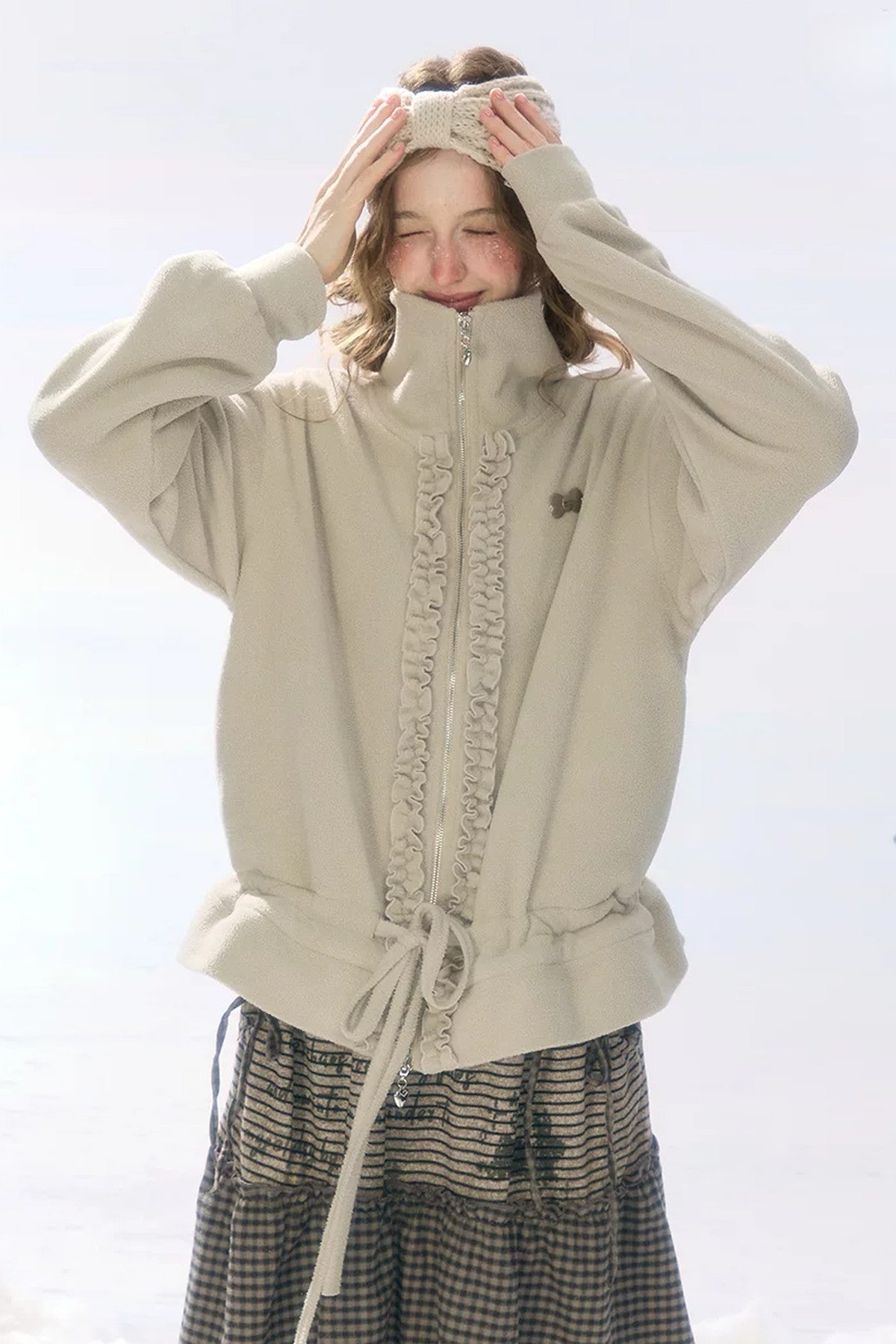 Veste en polaire grise et abricot à fermeture zippée et cordon de serrage
